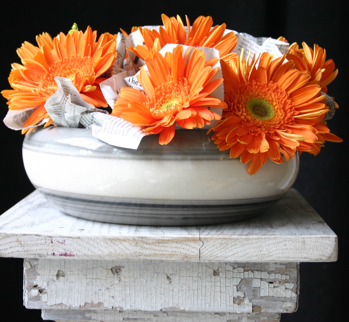 Contrasts interest me - I enjoy the surprise of unlikely duos. I used newspaper and wrapped it around the stems of these gerbera daisies and tucked it in between the stems.