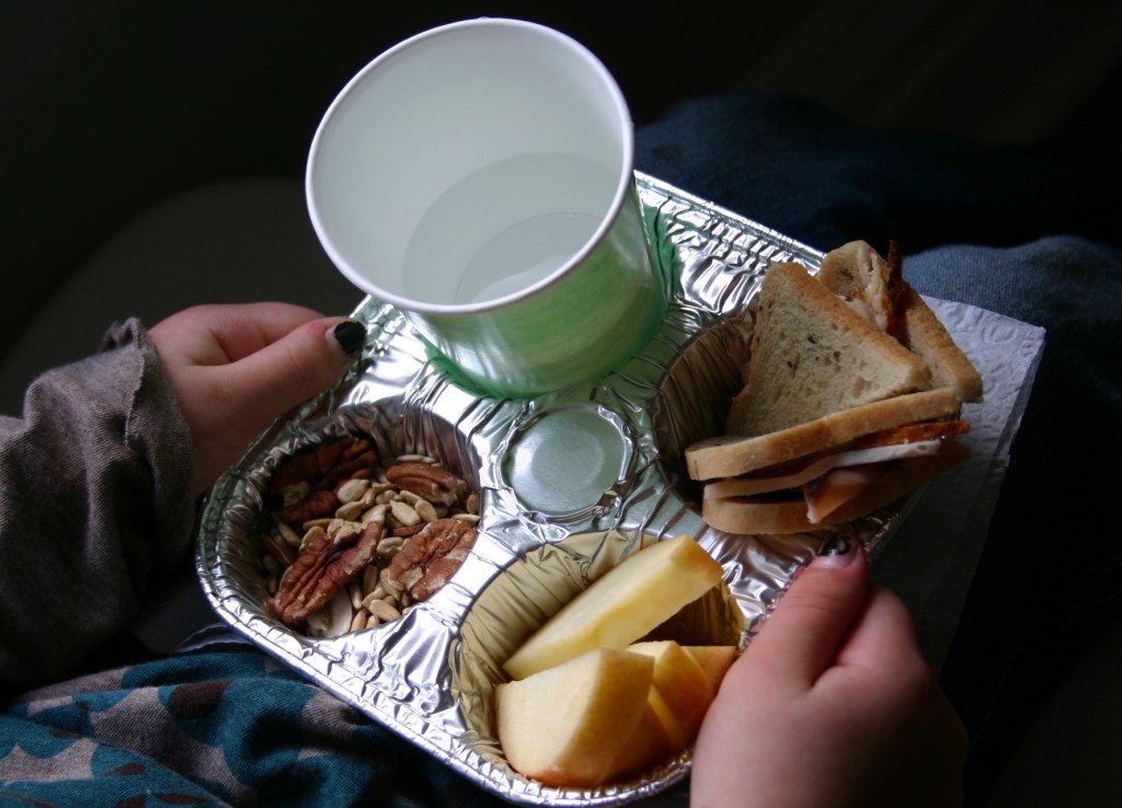 img_4869 A foil cupcake tin with four sections holds apple slices, trail mix, a small turkey sandwich - made from cocktail rye bread - and a cup of water. This makes a perfect compartmentalized tray for small laps. For breakfast- try using a hard-boiled egg, mini bagel and orange sections.