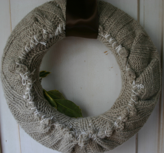 I wrapped the sweater around the wreath frame and stitched it closed using a large sewing needle.