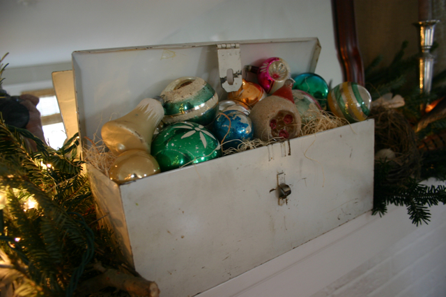 My old tool box is filled with wood shavings and vintage Christmas ornaments.