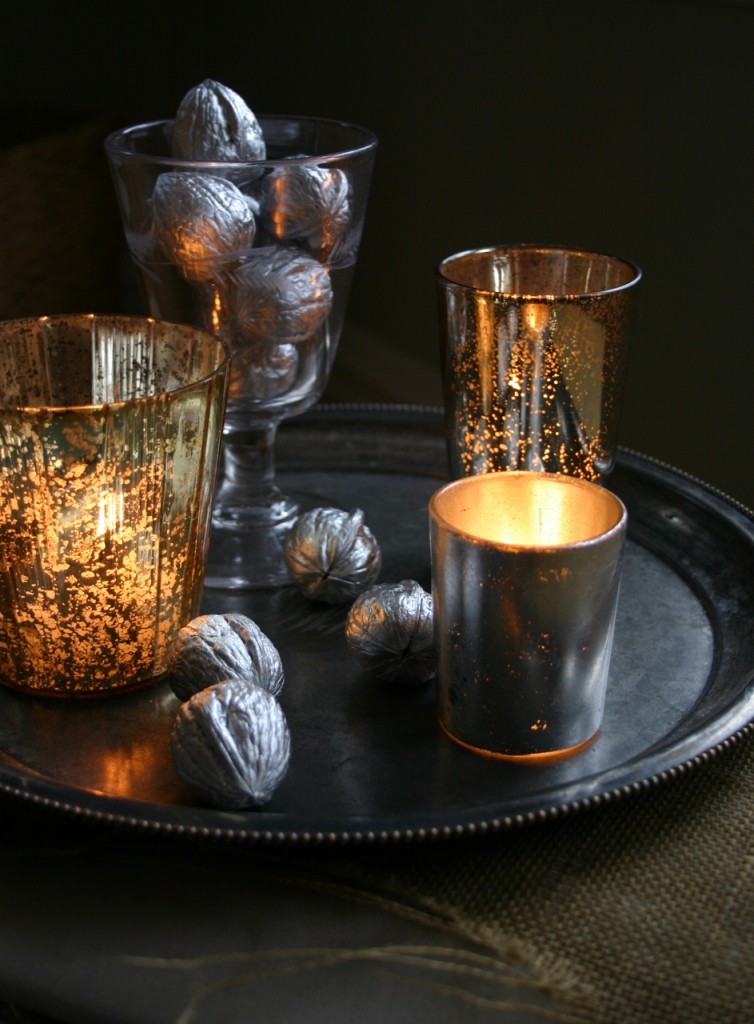 img_5517 Walnuts, spray painted silver, mix in among pewter and silvered glass votives to create a glimmering centerpiece.
