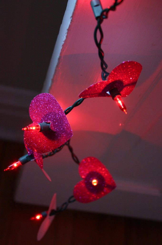 A short strand of 35 red lights are decorated with red glittery paper hearts.