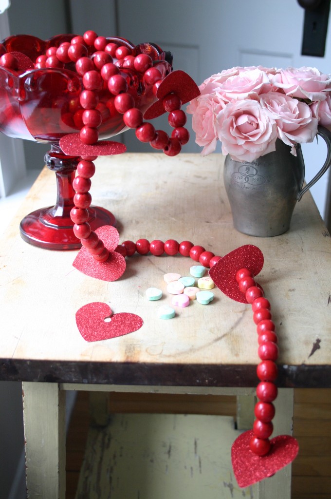 Red wooden beads make a wonderful Valentine's Day garland with the addition of a few more of those glittery paper hearts.