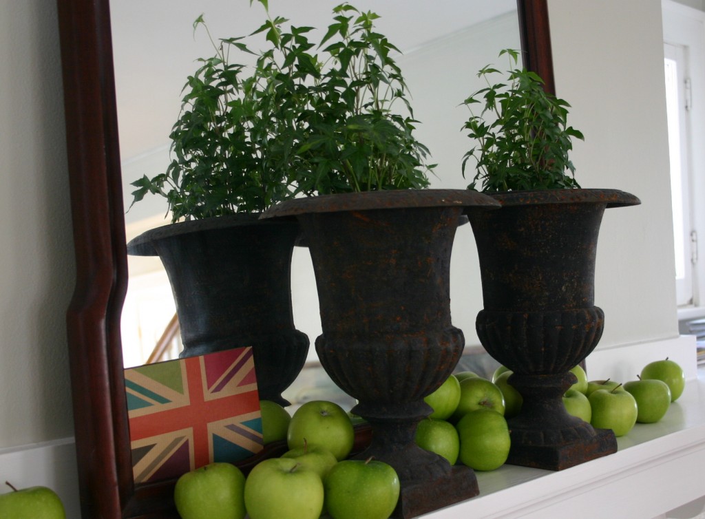 img_6289 My mantel - several green apples spill out around two urns filled with ivy.