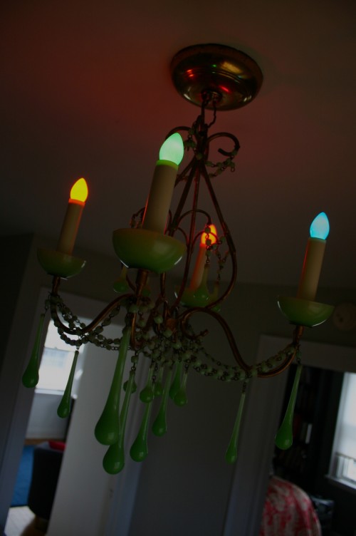 IMG_9441 While shopping for a replacement bulb for my chandelier, a package of colored C-9 Christmas bulbs caught my eye. A package of 4 cost $0.99 - so I thought I'd go for it for fun. When my kids came home from school they screamed with delight to see this.