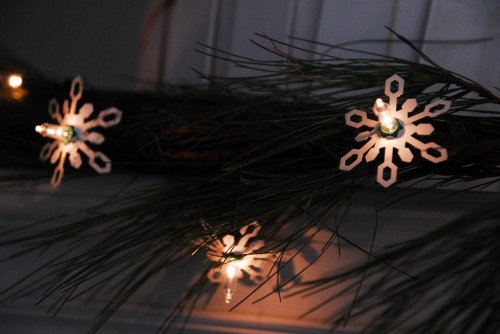 DSC_0186 Using a snowflake paper punch and a few pages from an old book, a plain strand of white holiday lights are looking a little brighter.
