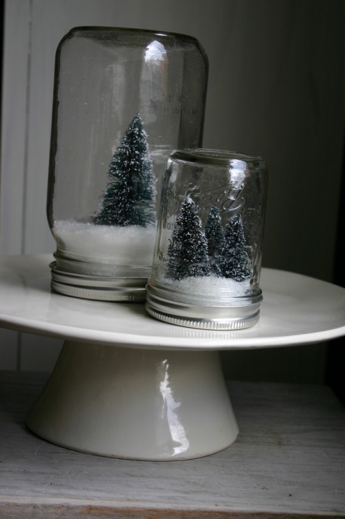 For this project you will need: Mason jars (available in a variety of sizes at craft and grocery stores for $1.00- $2.99 a piece), bottlebrush tree (I got a bag of 20 different sized trees for $10.00 at a craft store), artificial snow and a glue gun or floral stick.