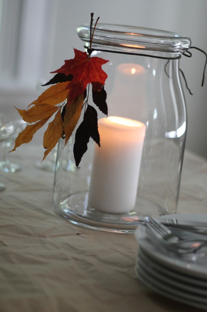 Dress up a candle jar with a tassel made from dried fall leaves.