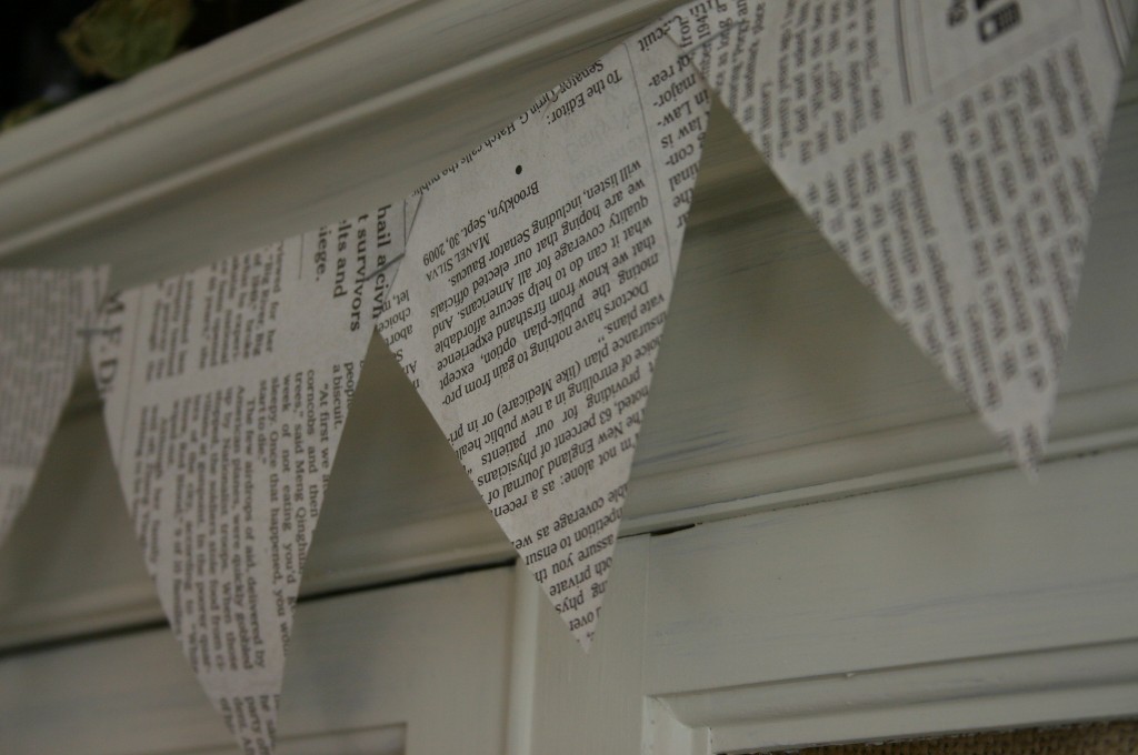 Triangles cut from newspaper and stapled together, make an easy garland.